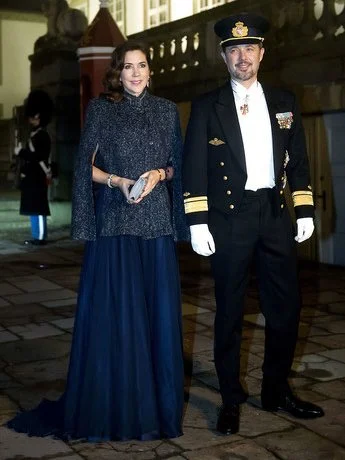 Crown Princess Mary wore Julie Fagerholt Heartmade Benina cape and Lasse Spangenberg gown, J Furmini clutch. Crown Prince Frederik