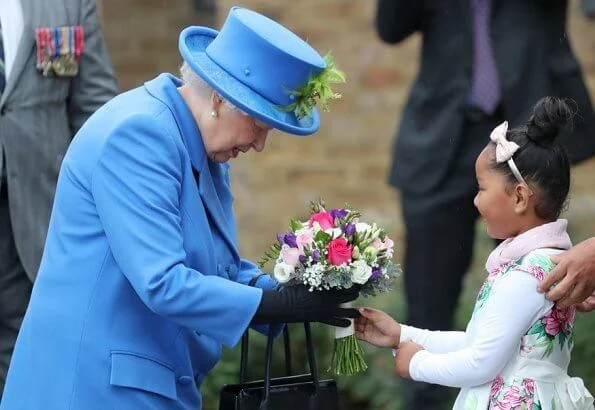 Queen Elizabeth opened the new housing development of Haig Housing.  Pearl earring and pearl necklace, diamond brooch