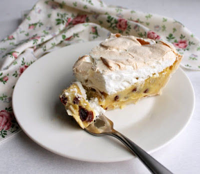 If this sour cream and raisin pie tastes like something your grandma would make, it's because she probably would! This pie is sweet, creamy and delicious with a pillow of fluffy meringue on top. bite of sour cream raisin pie on fork