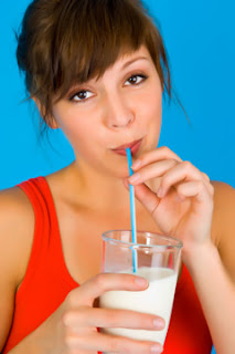 Woman Drinking Milk With A Straw
