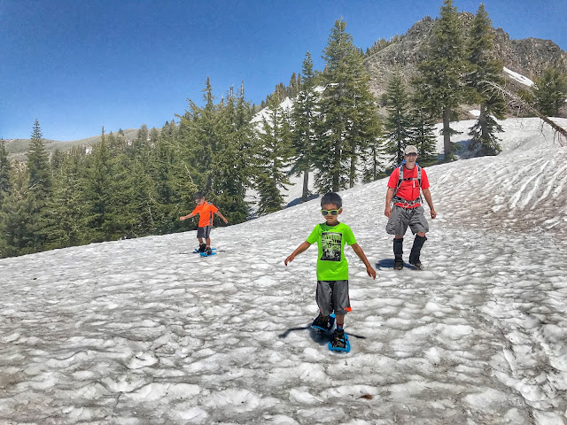 Kiddos snowshoeing down Castle Peak