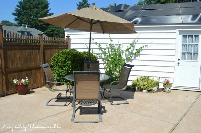 Garden Patio with table and chairs and red umbrella