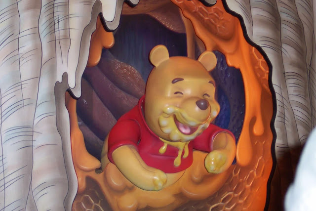 Pooh Eating Honey The Many Adventures of Winnie The Pooh Magic Kingdom Disney World