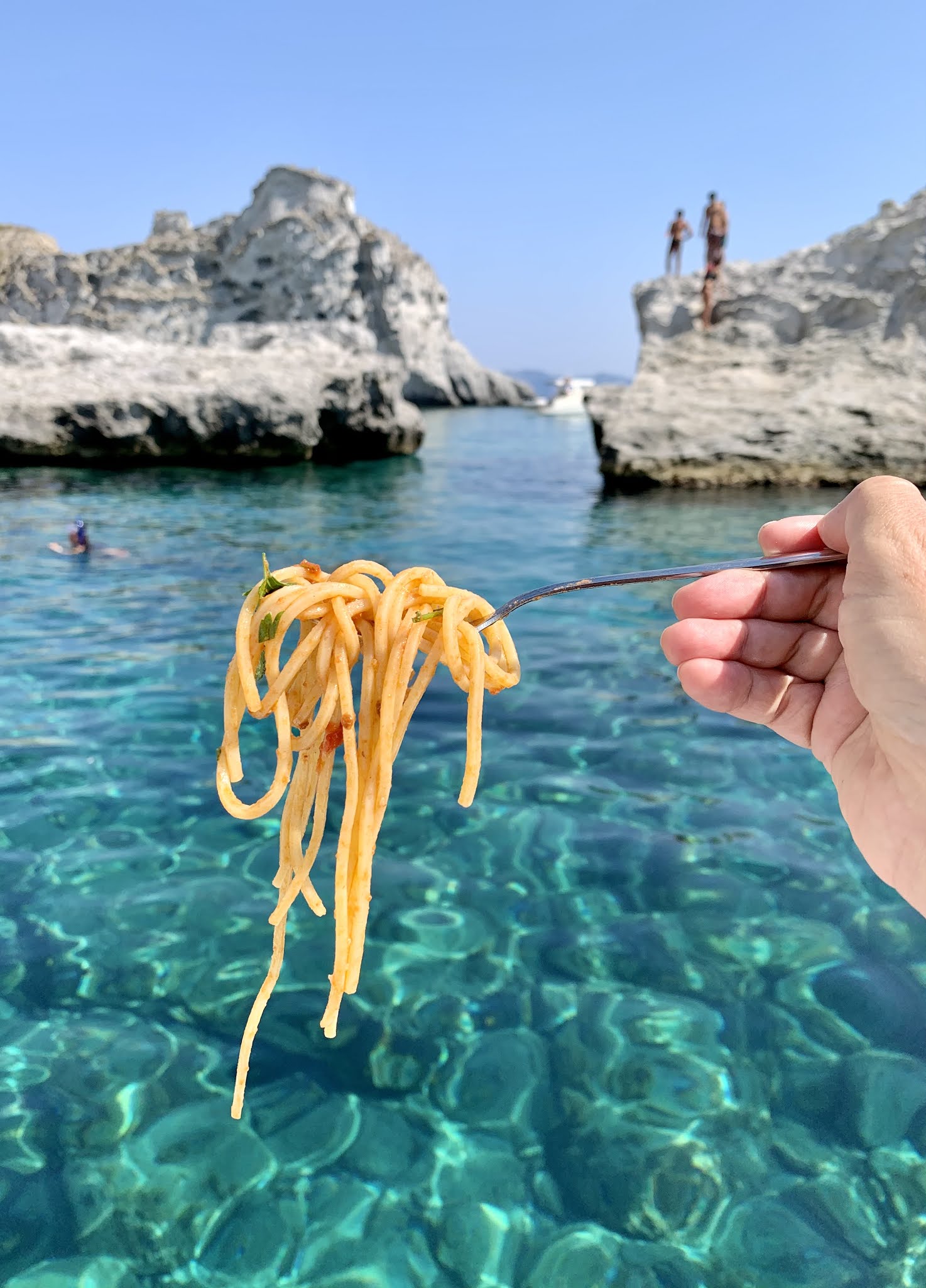 spaghetti in front of turquoise sea in Palmarola