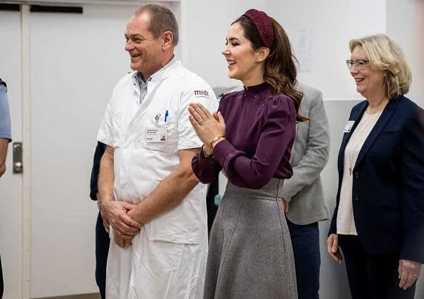 Crown Princess Mary attended the opening of Viborg Regional Hospital's new emergency center. burgundy blouse, grey midi dkirt, grey wool coat