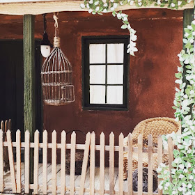 One-twelfth scale miniature Australian cottage porch with a bird cage and a woven chair