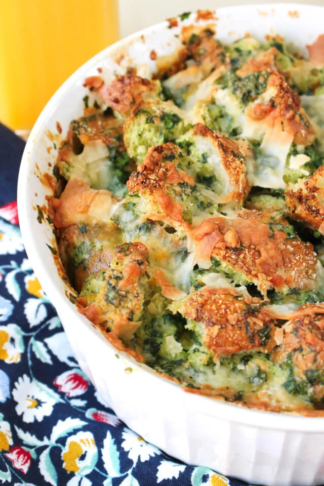 This Three Cheese Spinach Strata is a cheesy, french bread filled, make ahead egg casserole that makes a hearty breakfast or brunch.