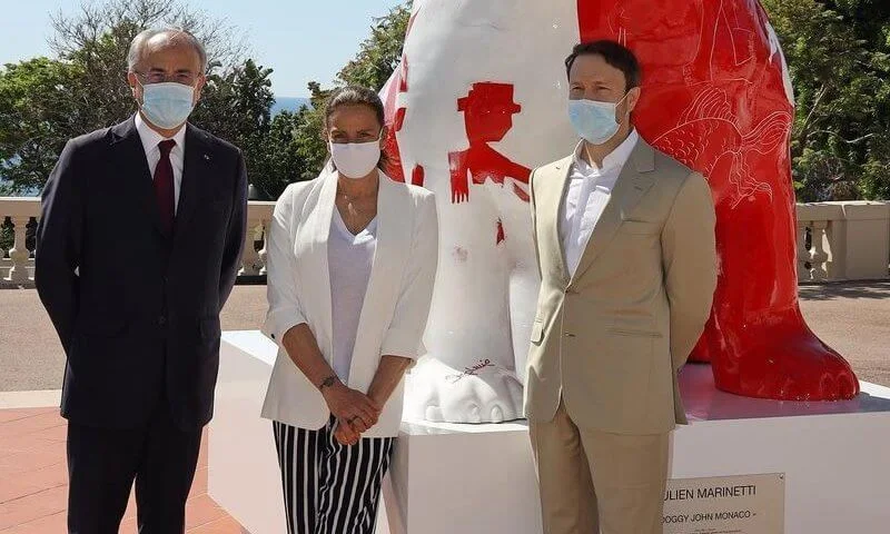 Princess Stephanie, Louis and Marie Ducruet at the inauguration of the sculpture of Doggy John. White jacket, striped pants, red bag