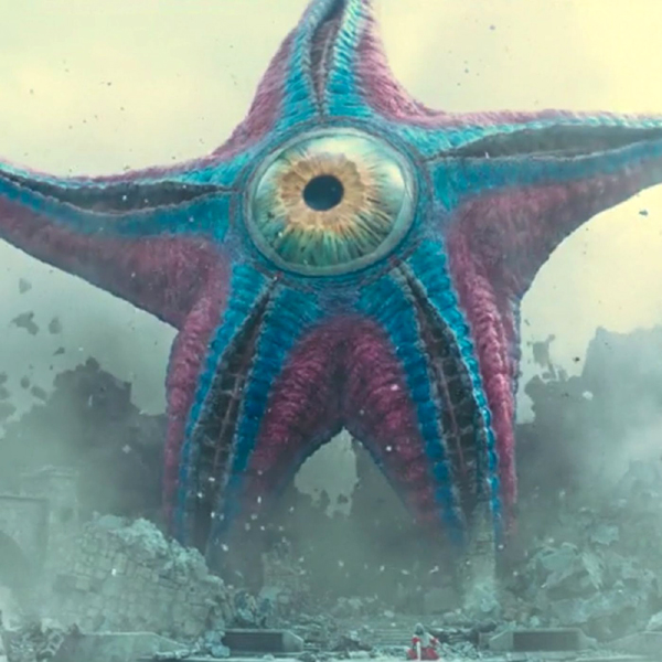 Starro the Conqueror gets ready to wreak havoc on innocent civilians as Harley Quinn looks on (near the bottom of the frame) in THE SUICIDE SQUAD.