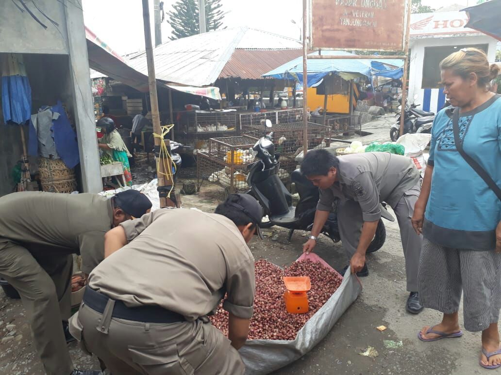 Saat petugas Satpol PP sedang memindahkan barang dagangan pedagang dari trotoar dan bahu jalan di Kota Tanjungbalai, Selasa (3/7)  Saat petugas Satpol PP sedang memindahkan barang dagangan pedagang dari trotoar dan bahu jalan di Kota Tanjungbalai, Selasa (3/7)