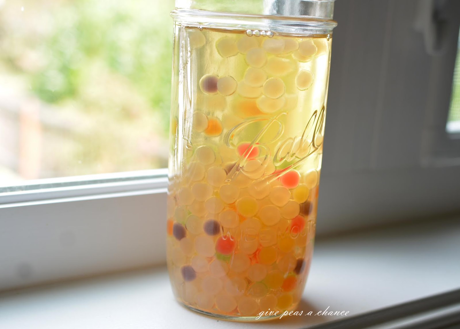A close-up shot of a glass of Vietnamese Egg Coffee Tea (Trà Trứng) with tapioca pearls, showcasing its creamy texture and layered appearance.