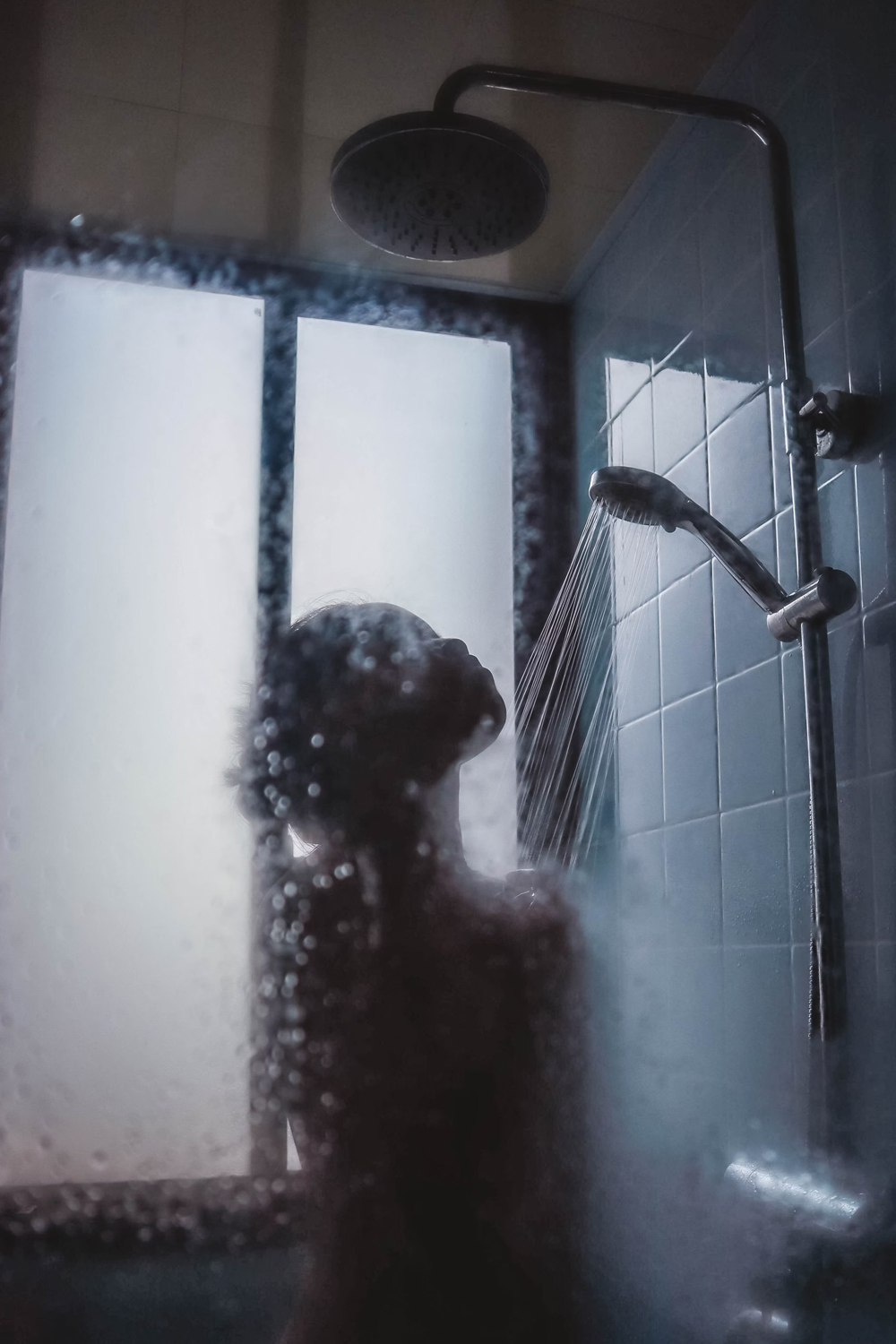 a sillouette of a woman taking shower