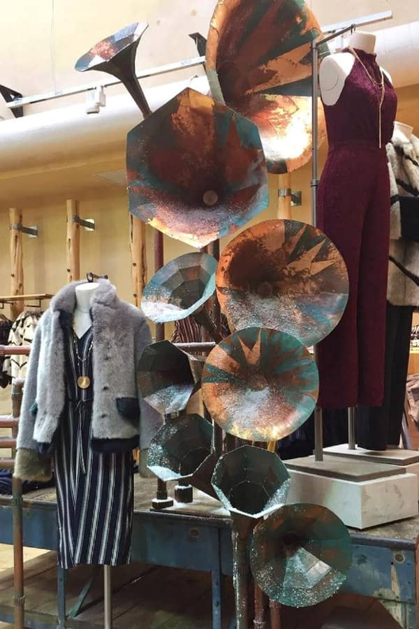 clothing store display of painted cardboard musical horns