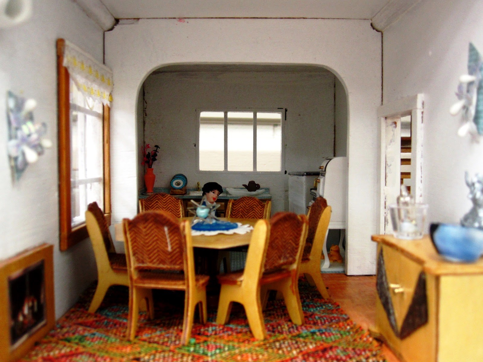 Kitchen/ dining room of an Art Deco moderne-style dolls house by Anne Reid