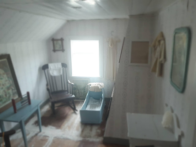 View of one of the small bedrooms upstairs in the museum, with the outline of the original chimney visible to the right.