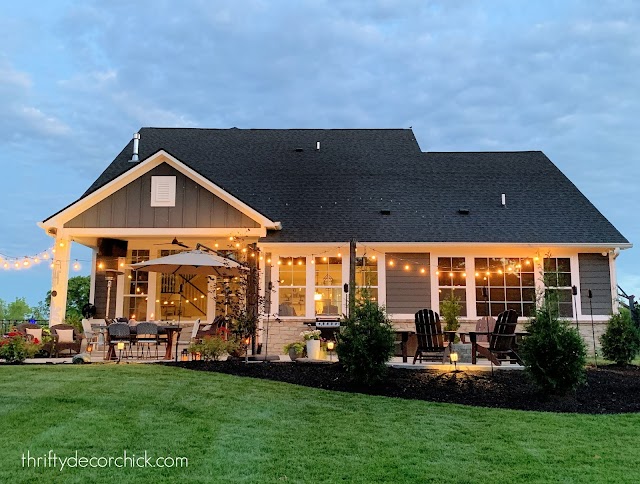 rear view gray house white trim patio fire pit