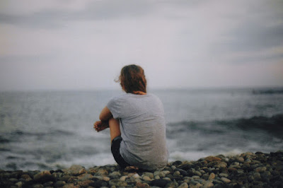 Girl sitting and waiting for love onshore of ocean