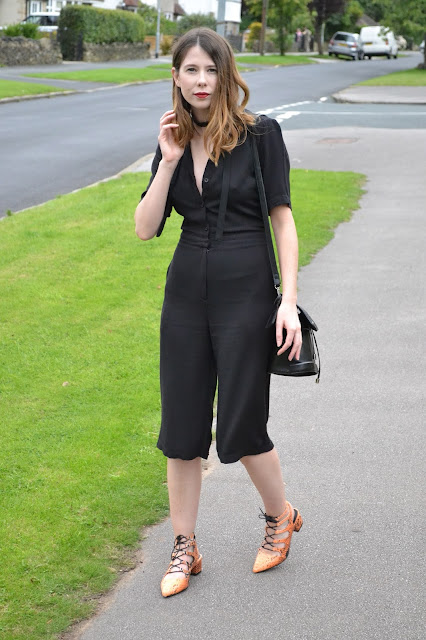 Womens affordable highstreet fashion blog featuring British street style. Topshop Black button down playsuit with cut out back. orange snake skin lace mid heel shoes from ASOS. Black suede and leather and Topshop