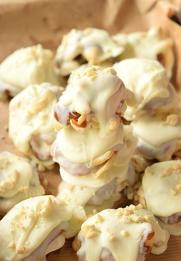 delicious homemade white chocolate caramel cashew clusters arranged on a tray piled up