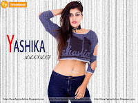 sexy yashika aannand image in blue color jeans and top along नाभि piercing pin