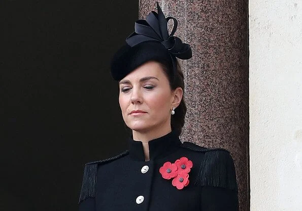 Kate Middleton wore a bespoke black military coat by Alexander McQueen, and a Philip Treacy hat. Queen's diamond and pearl earrings