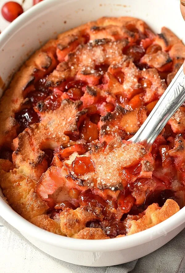 scooped out easy cherry cobbler in a white baking dish