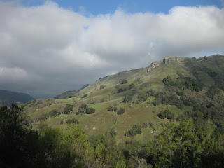 Clouds gather beyond a sunlit hillside along Calaveras Road, Alameda County, California