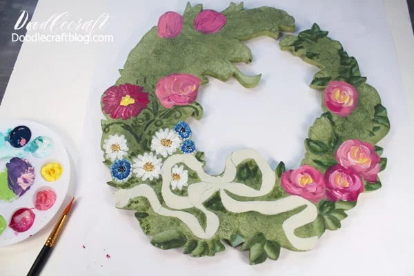 Using acrylic craft paint on a wooden cut out wreath.
