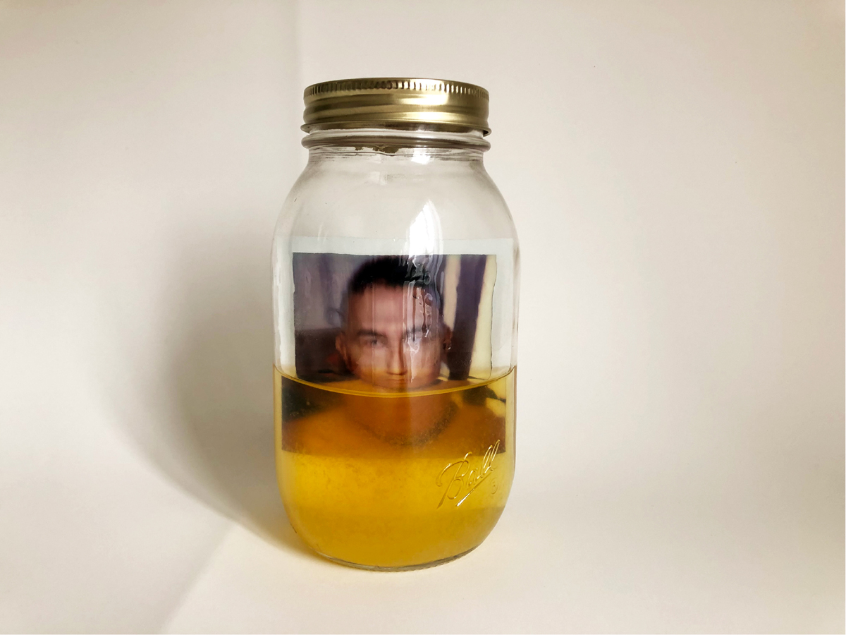 Rubén Esparza, Self Portrait Piss Jar, 2019, Polaroid, urine, and jar. 