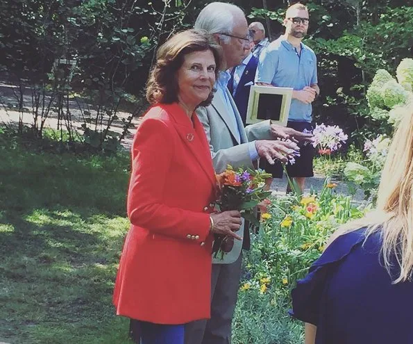 Queen Silvia wore a red long blazer for SilviaBo project at Ikea in Älmhult and visit the Themed Gardens exhibition at Solliden