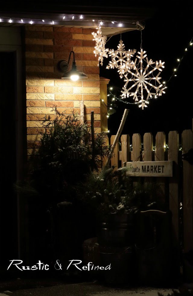 Decorating our home outside with christmas lights and gorgeous containers filled with live plants and christmas decor.