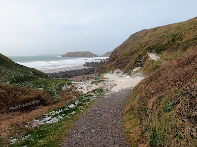 A praia de Marloes Sands Beach com espuma no caminho - País de Gales