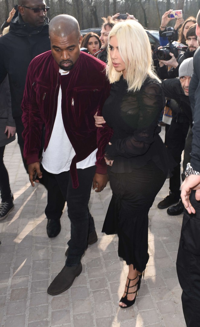 Kim Kardashian and Kanye West attend the Louis Vuitton Fall/Winter 2015 Paris Fashion Week Show
