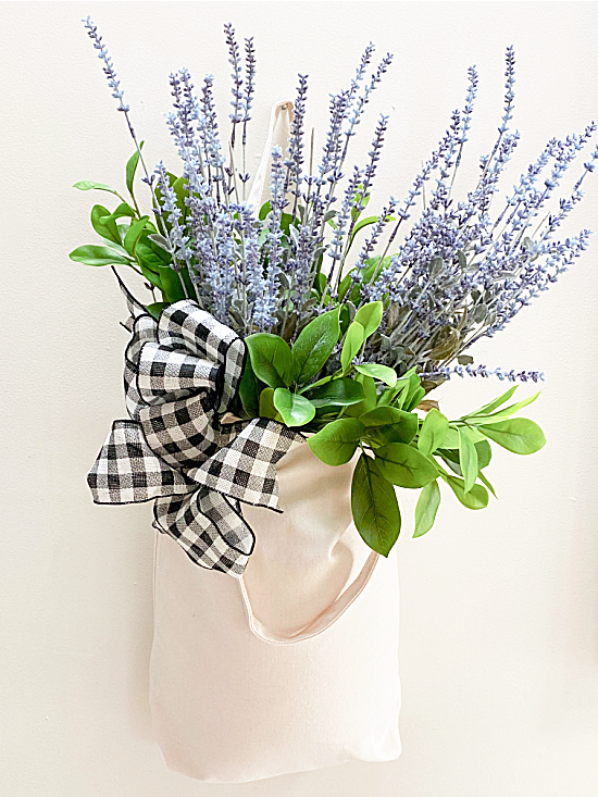 flowers and a bow on a muslin market tote