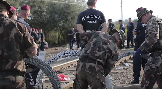 Hungarian army and police erecting fencing near Serbia to deter migrants.