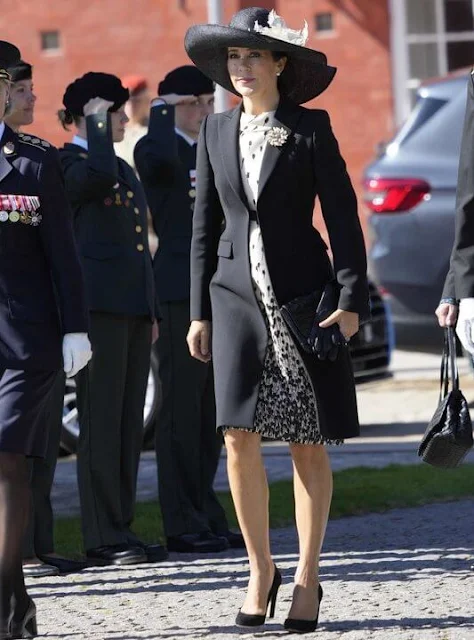 Crown Princess Mary wore a cappotto black coat by Prada, and printed silk dress by MaxMara. Jimmy Choo Billie pumps