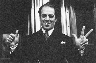 "How many quartets did I write before this one?" Actually Villa-Lobos is demonstrating one of the hand-gestures he developed to indicate "do-re-mi" pitches when conducting children's choirs of a thousand or more.