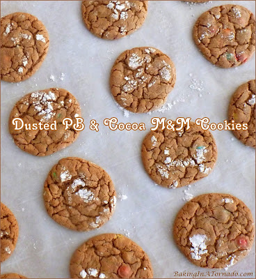 Dusted PB & Cocoa M&M Cookies start with a mix and go from there adding flavor, crunch, and topped with powdered sugar. | Recipe developed by www.BakingInATornado.com | #recipe #cookies