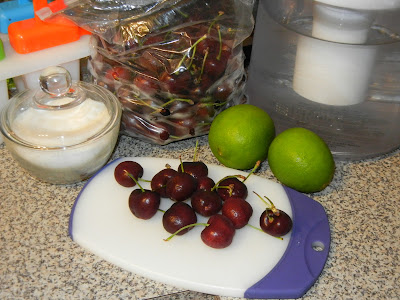 ingredients for cherry ice pops with cherries on a cutting board 