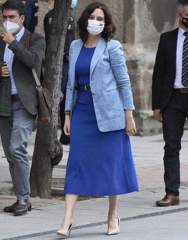 Queen Letizia wore a navy belted wool v-neck midi dress from Massimo Dutti, and white cashmere coat from Carolina Herrera