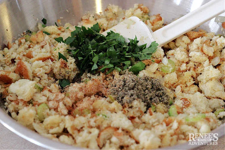 Process photo for Sage and Onion Stuffing mixing in parsley, sage, thyme, and nutmeg.