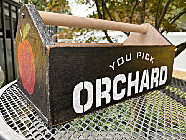 wooden crate with stencil and apple