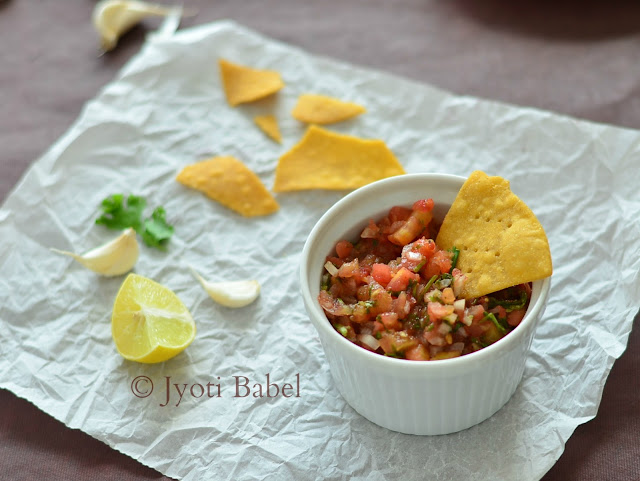 Roasted Tomato Salsa is one of the must accompaniments with tortilla chips. A medley of chopped roasted tomatoes, onions, chillies, coriander, spices and lemon juice makes for a lip-smacking dip. Recipe at www.jyotibabel.com