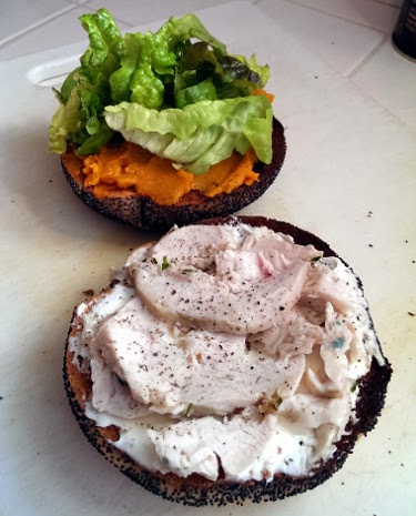Thanksgiving leftovers bagel with chicken, sweet potato, cream cheese, and greens