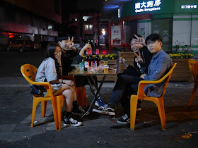 Four youth eating outside in Jiangmen