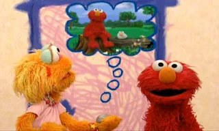 Zoe's friend Rocco is imagining Elmo is a rock. Elmo and Elmo Rock sit on a log. Sesame Street Elmo's World Friends Tickle Me Land