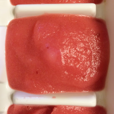 Mixed fruit puree in an ice cube tray to get ready for freezing.