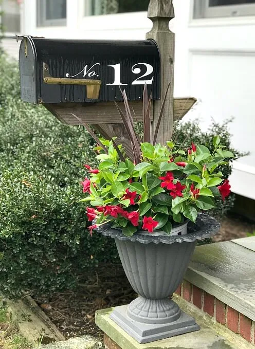 Mailbox with potted plant in iron planter
