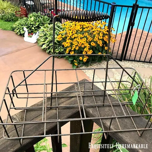 Vintage Wire Milk Bottle Holder on wooden deck