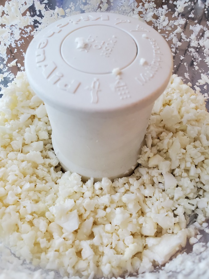 this is riced cauliflower in a kitchenaid food processor